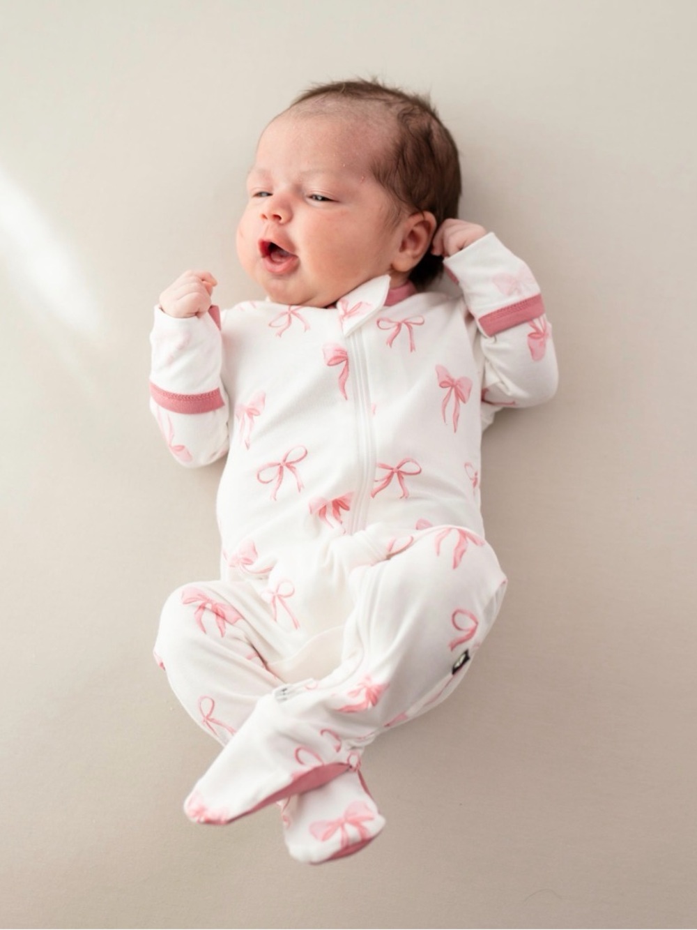 Kyte Zippered Footie in Pink Bow Print